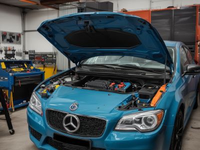 Master technician Richard Thompson in professional automotive repair facility with modern diagnostic equipment
